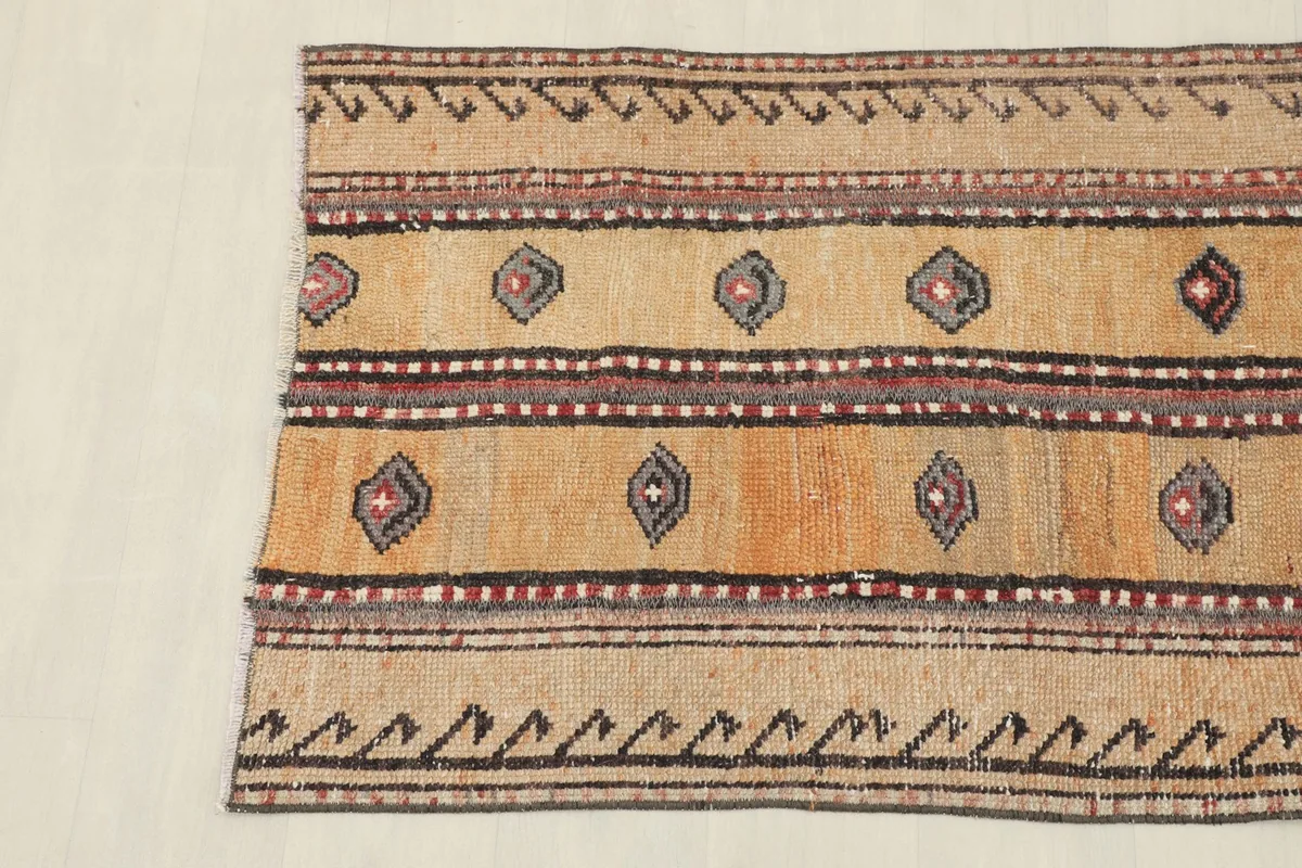 Detail view of the rug's left side, focusing on the border and field patterns.