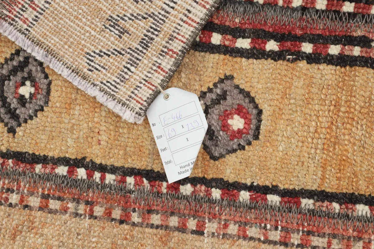 Close-up of the rug's texture with a product tag, showing the intricate details.