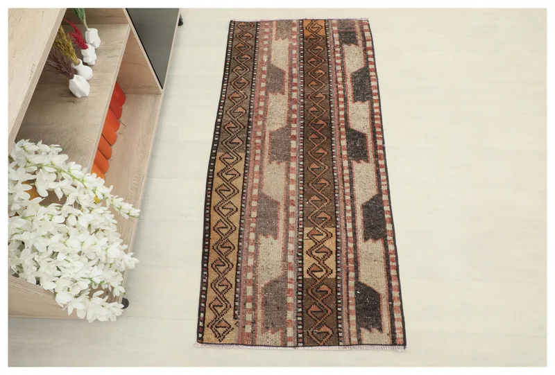 Full top view of the 2x5 vintage Anatolian rug with brown, tan, and rust geometric stripes.