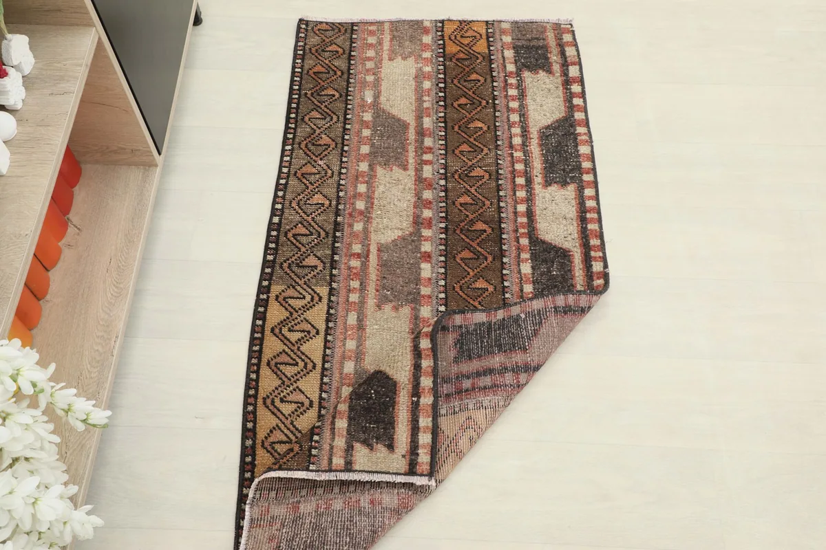 The rug partially folded to show its flexibility and the clean back of the weaving.