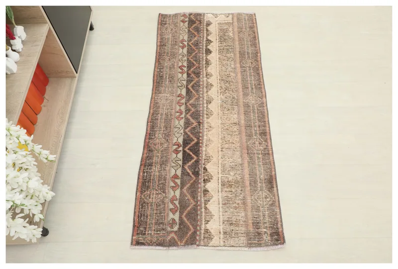 Full top view of the brown, beige, and rust striped vintage Anatolian area rug
