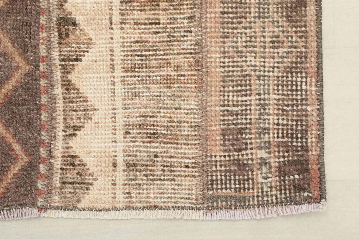 Close-up of the rug's edge, revealing the subtle color transitions and fringe detail
