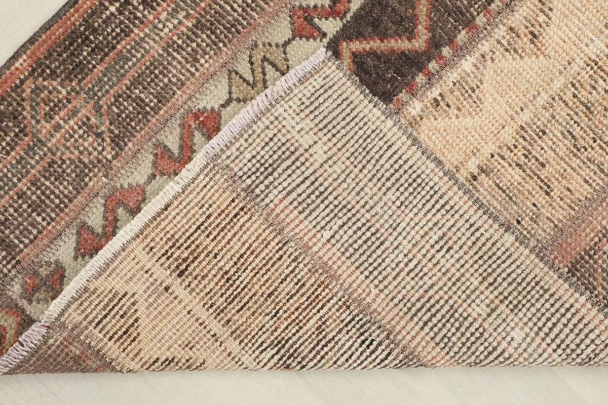View of the back of the rug, showing the cotton foundation and hand-knotting