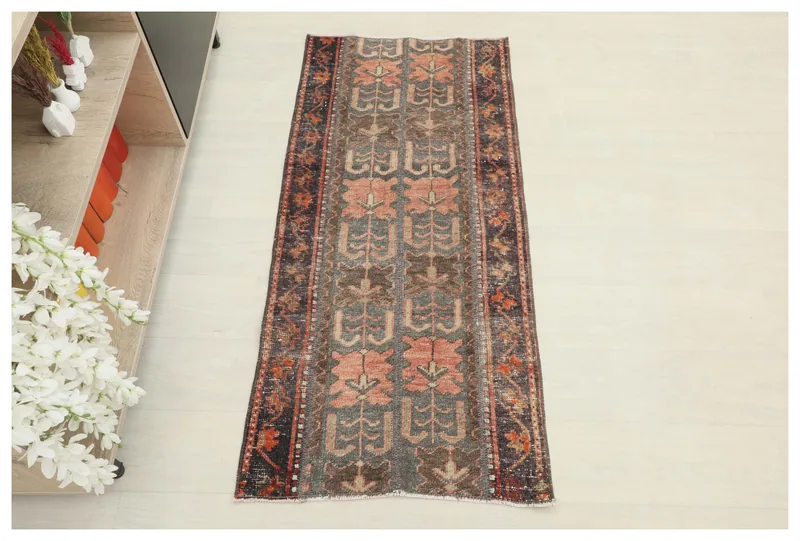 Full overhead view of the vintage Anatolian rug on a white background.