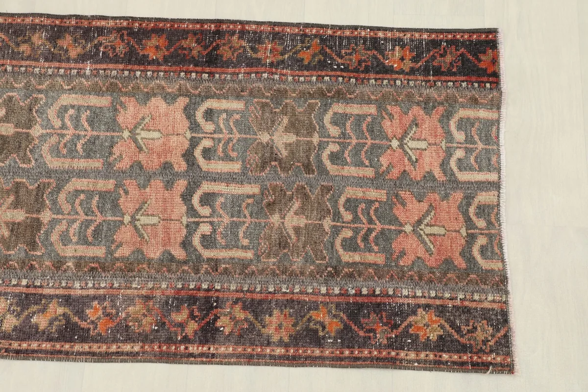 Close-up of the rug's central pattern and border, highlighting the geometric motifs.