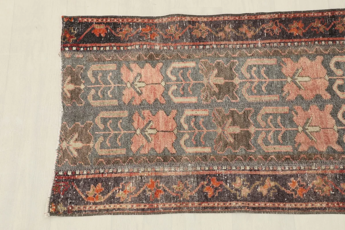Detailed section of the rug, showing the texture and color variations from wear.