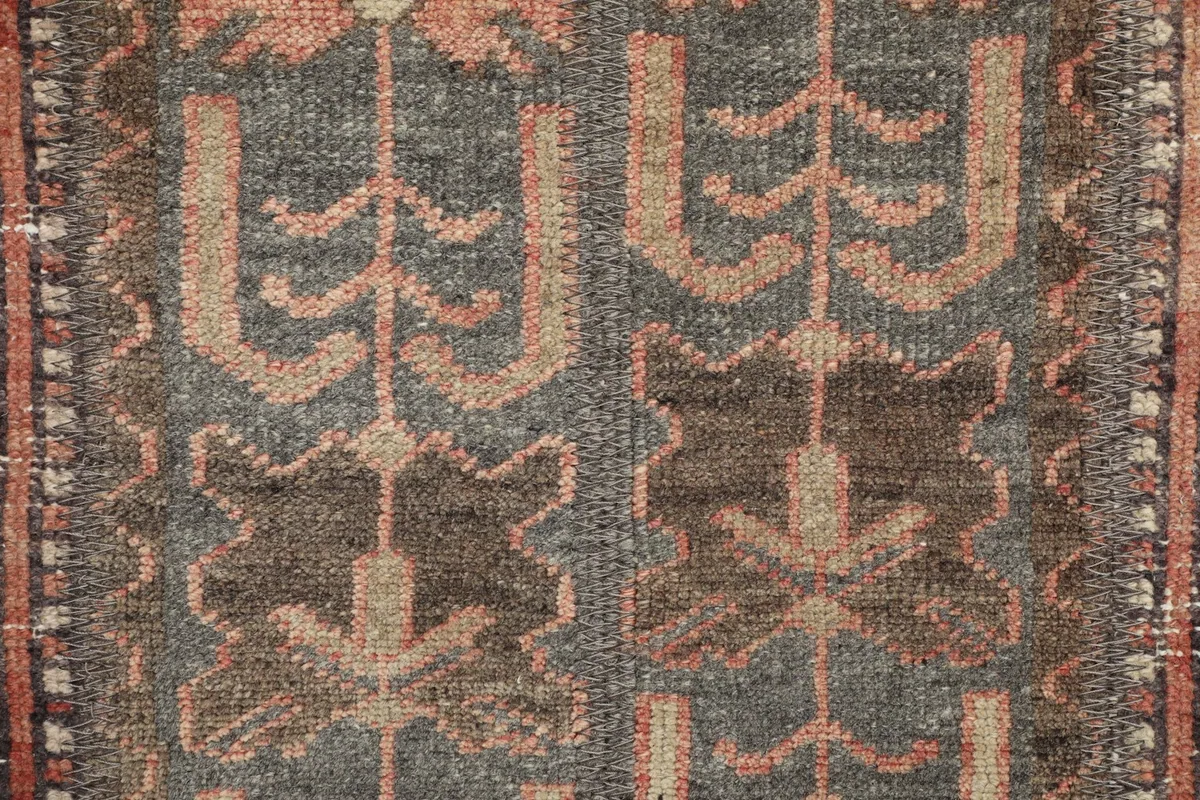 Macro view of the rug's low wool pile, showing individual knots and color depth.