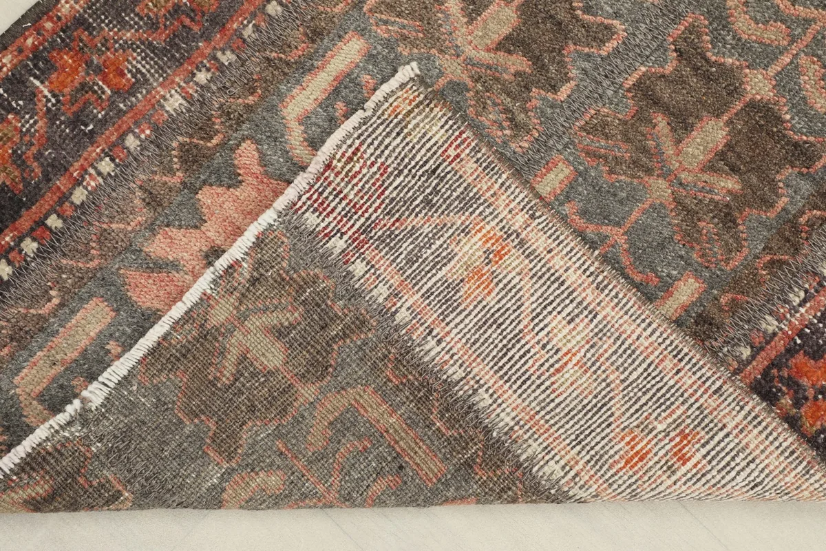 View of the rug's backside, revealing the cotton foundation and hand-knotted construction.
