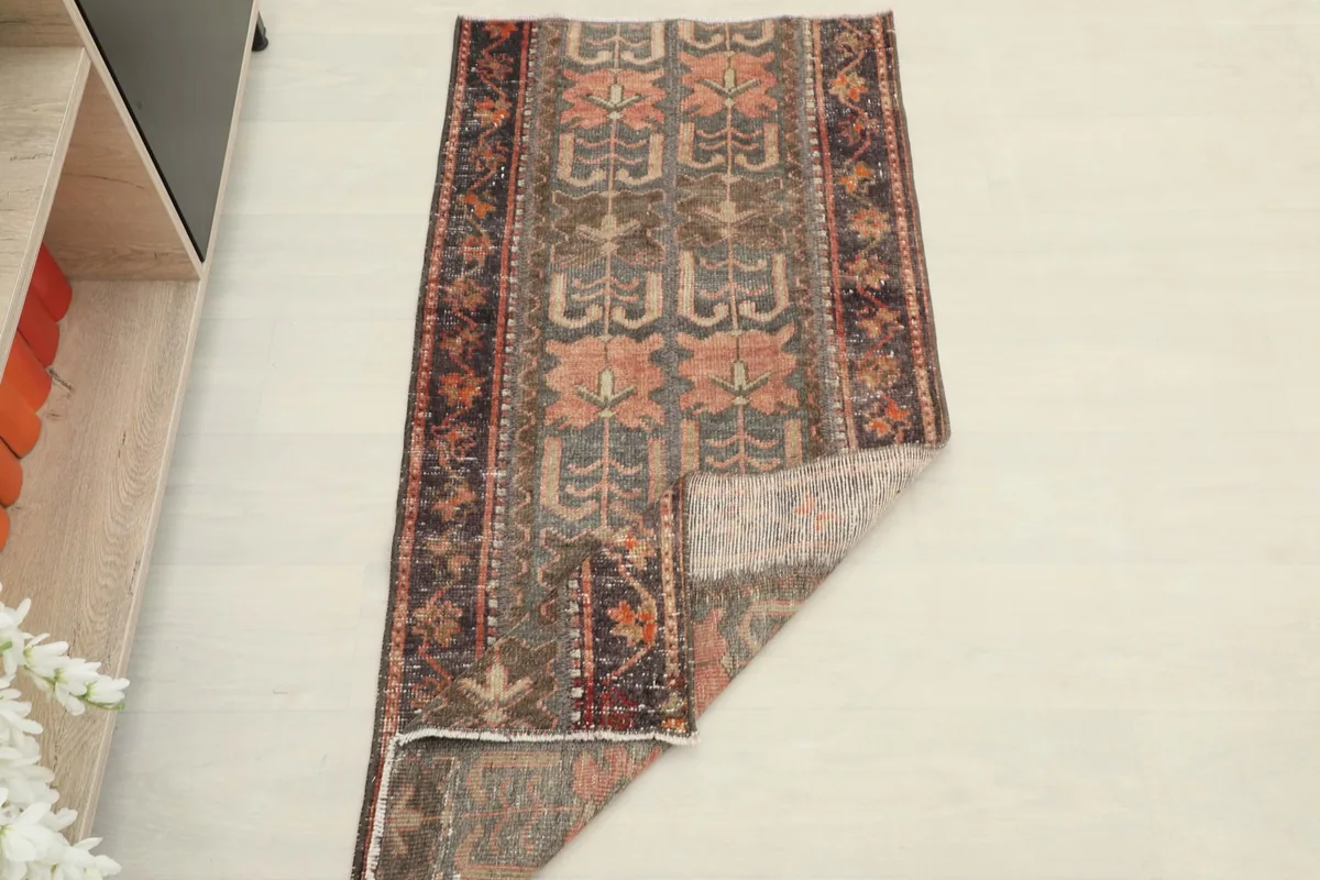 The rug partially folded, showing its flexibility and the reverse side.