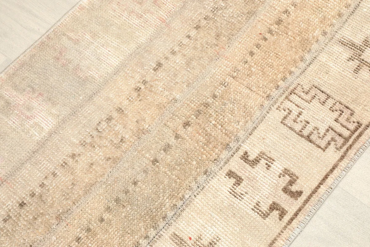 Angled view highlighting the varied textures and patterns within the beige patchwork sections