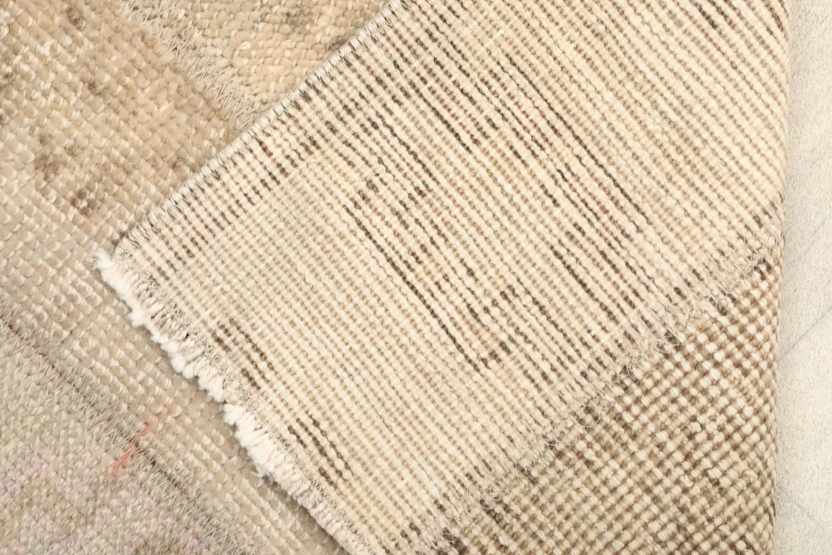 View of the rug's back, revealing the hand-knotted cotton foundation and wool pile
