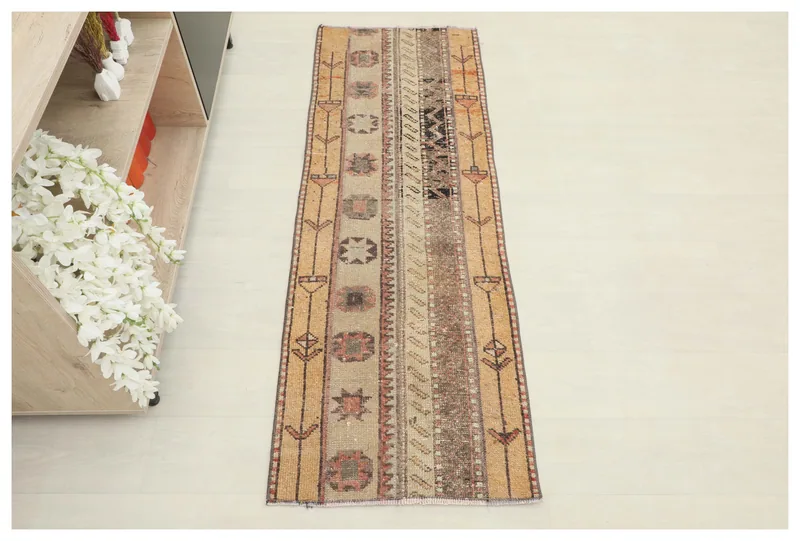 Full top view of the 1'10" x 5'3" vintage Anatolian runner rug on a white background