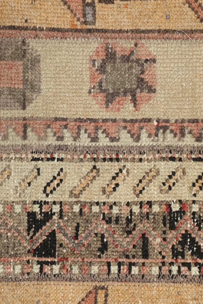 Extreme close-up of a specific tribal medallion motif and surrounding pattern details