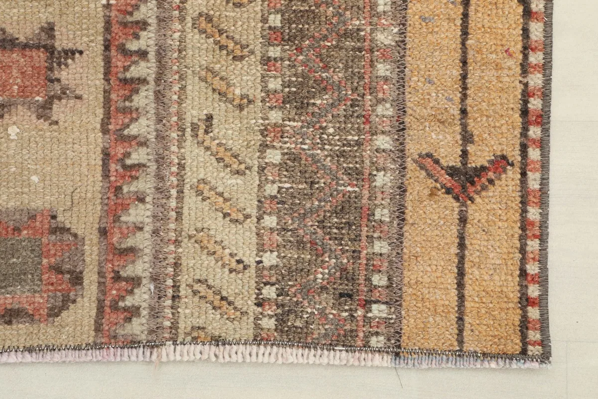 Close-up of the short, rustic fringe and edge finishing of the vintage hand-knotted runner