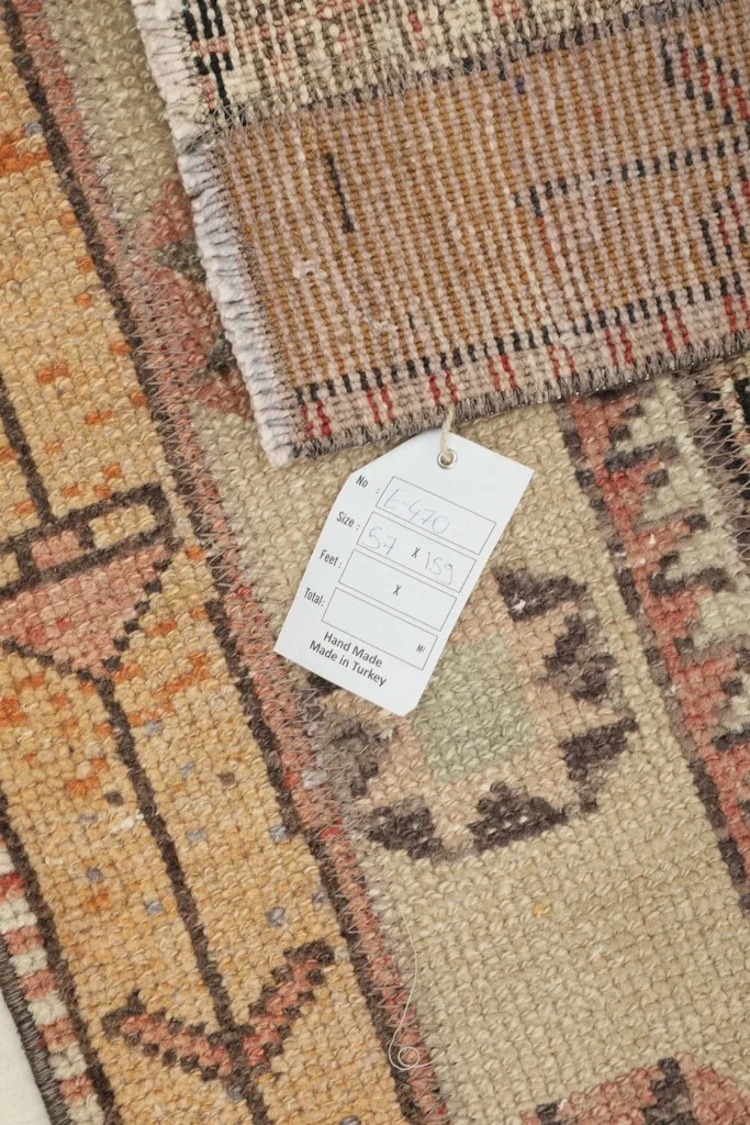 Close-up of the rug's texture and a tag indicating its hand-knotted origin from Turkey
