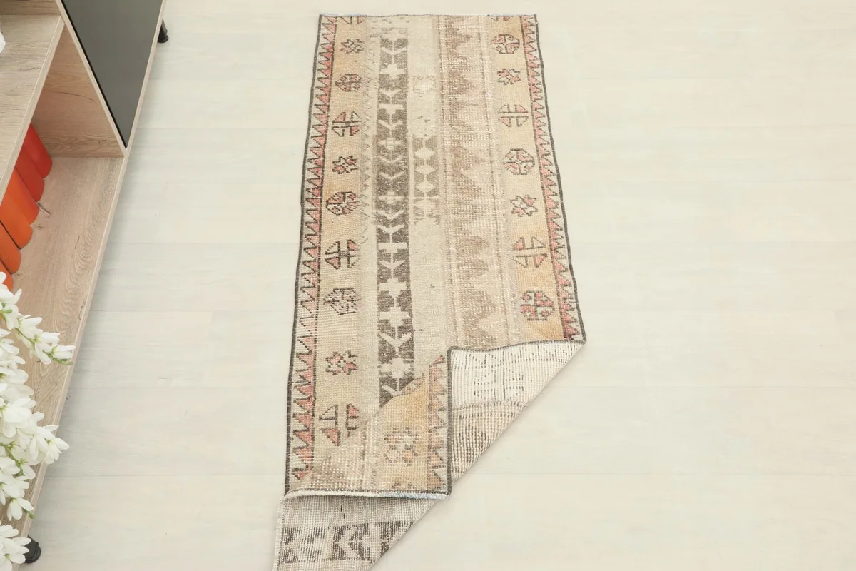The runner partially folded, displaying both the top and the back of the rug.