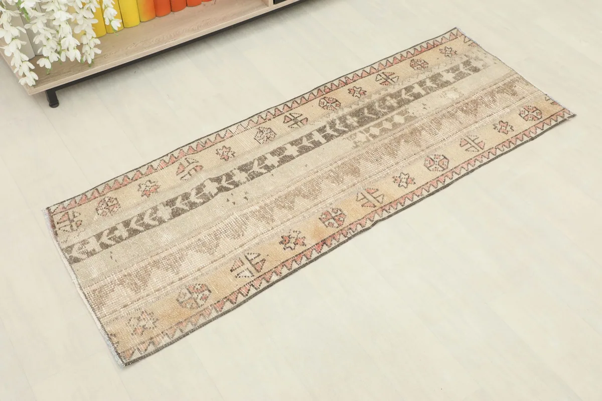Slightly angled overhead view of the hand-knotted runner, highlighting its geometric patterns and colors.