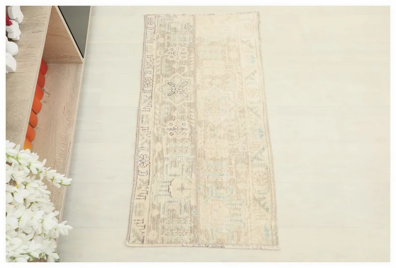 Full top view of the 1'9" x 3'6" beige and gray vintage Anatolian doormat on a white background.