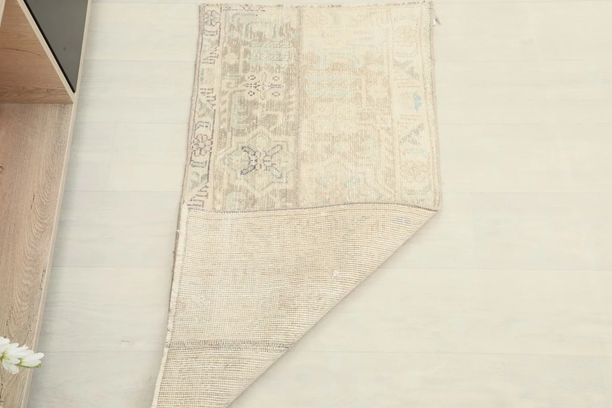 Partial view of the rug's back, demonstrating its flexibility and the quality of the weaving.