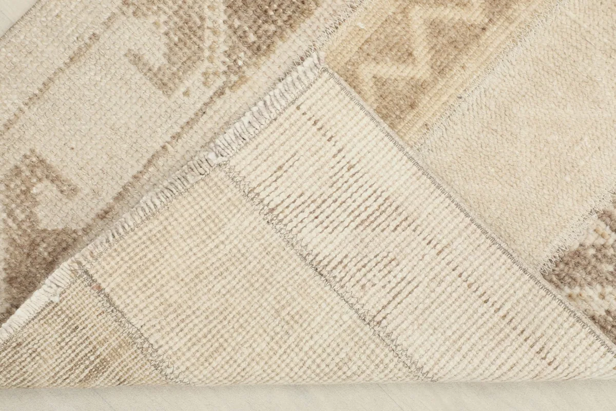 View of the back of the rug, revealing the cotton foundation and hand-knotted construction.