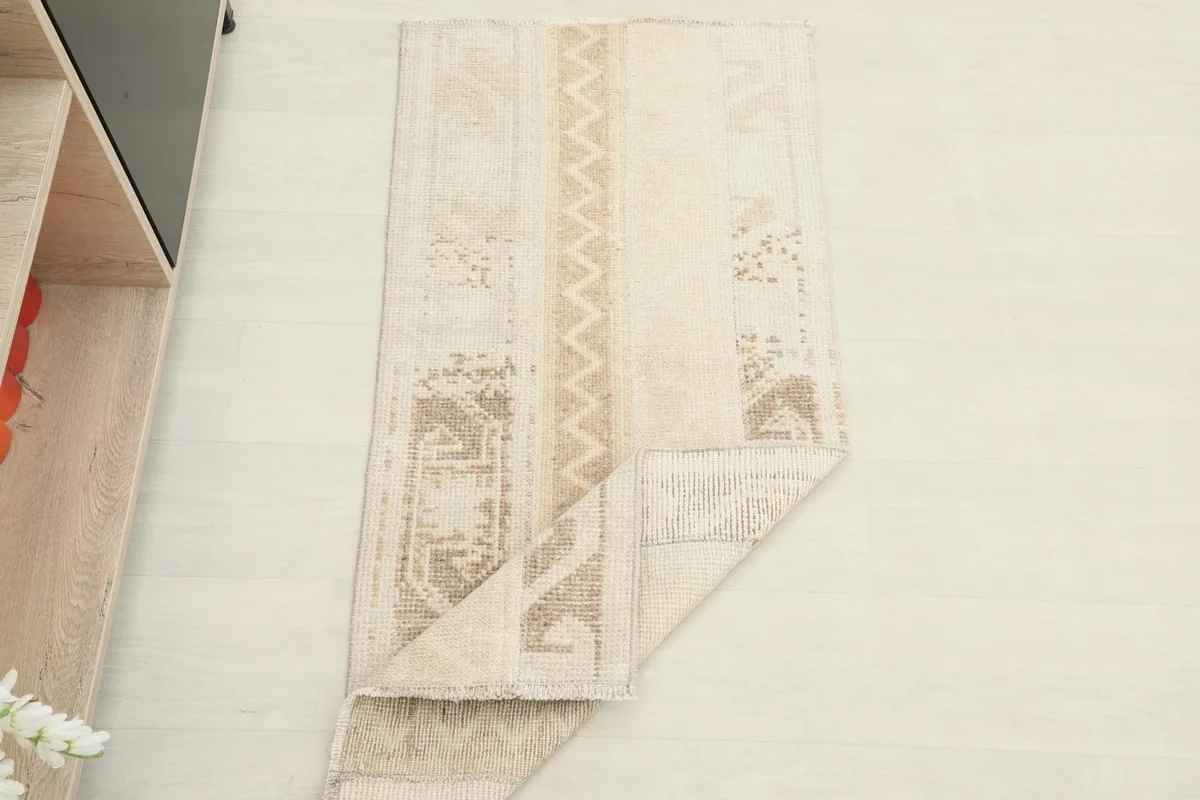 The rug partially folded, demonstrating its flexibility and texture.