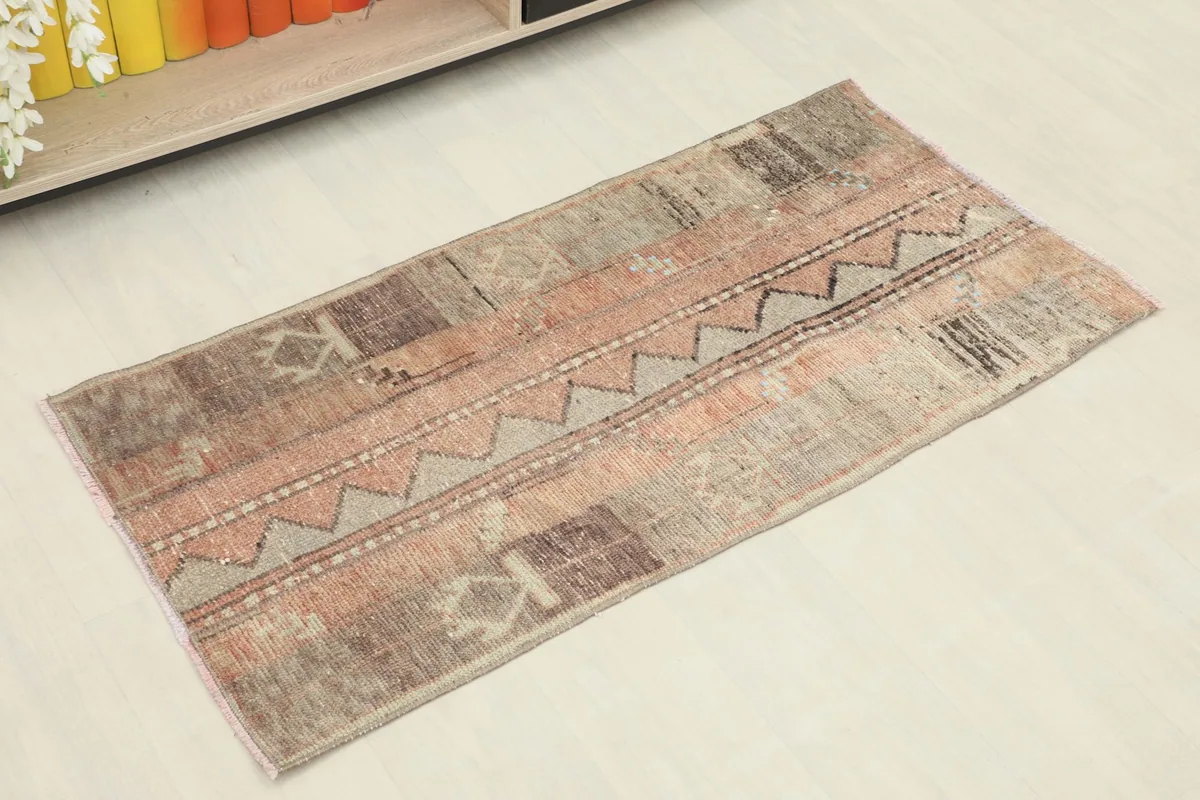 Angled overhead view of the hand-knotted wool rug showing its full design and colors