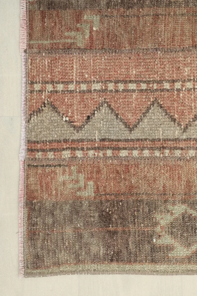Close-up of the rug's edge, showing the subtle fringe and side finish