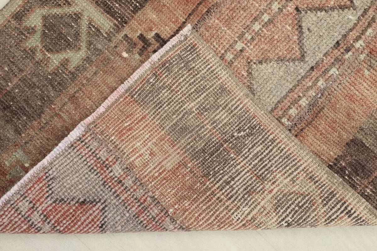 View of the rug's underside, revealing the cotton foundation and knotting detail