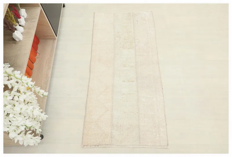 Full top view of the cream and beige patchwork vintage Anatolian rug on a white background.