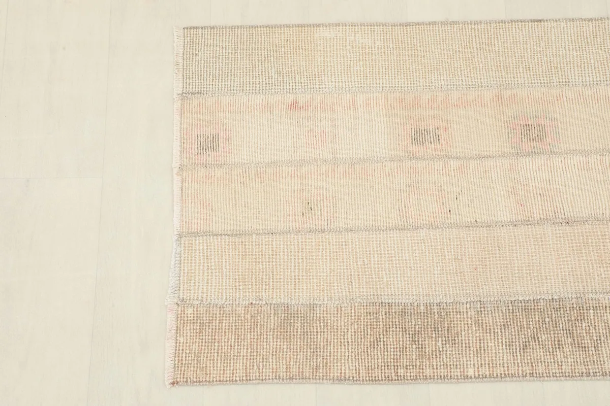 Detailed view of the rug's top corner, showing the tight weave and color transitions.