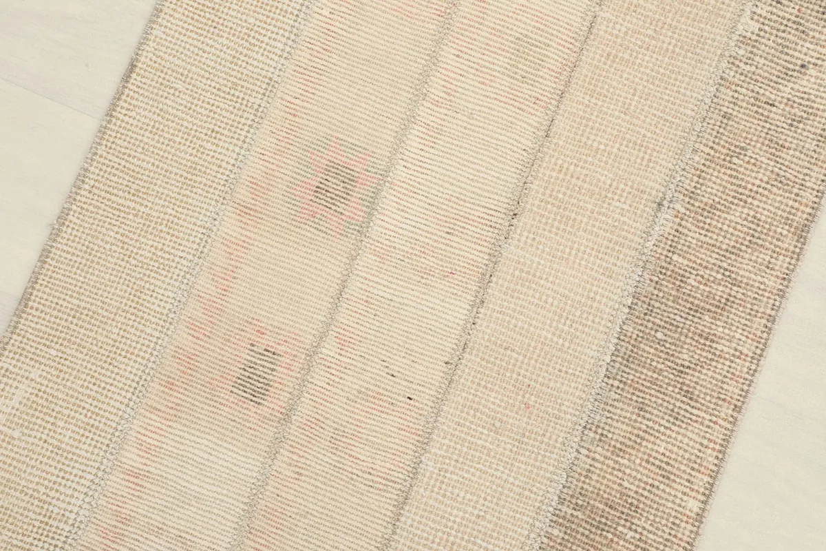 Close-up of the rug's central section, revealing the distressed texture and individual patches.