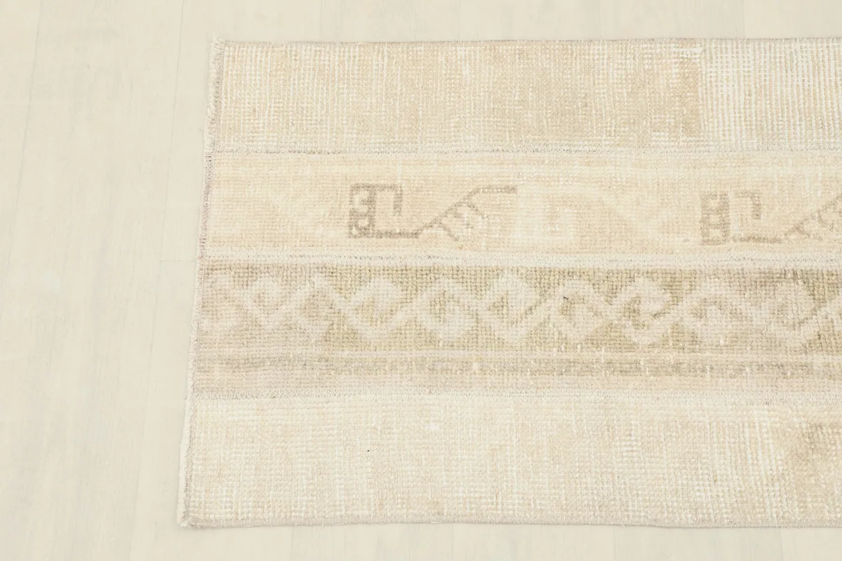 Detailed view of the central section of the rug, showcasing the intricate tribal patterns and color variations.