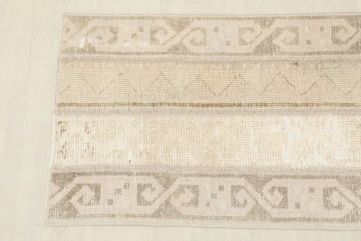 Detailed section of the runner rug, showing the tribal-inspired border design.