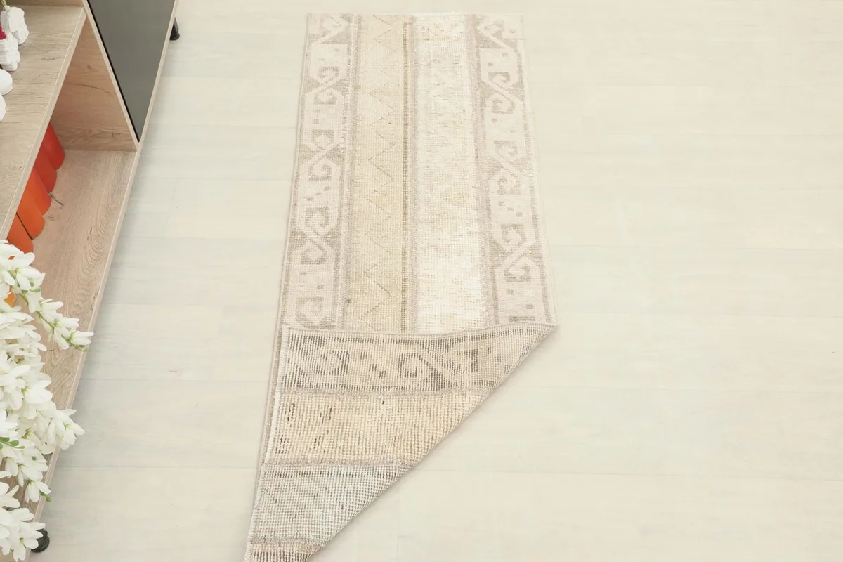 Runner rug partially folded, demonstrating its flexibility and construction.