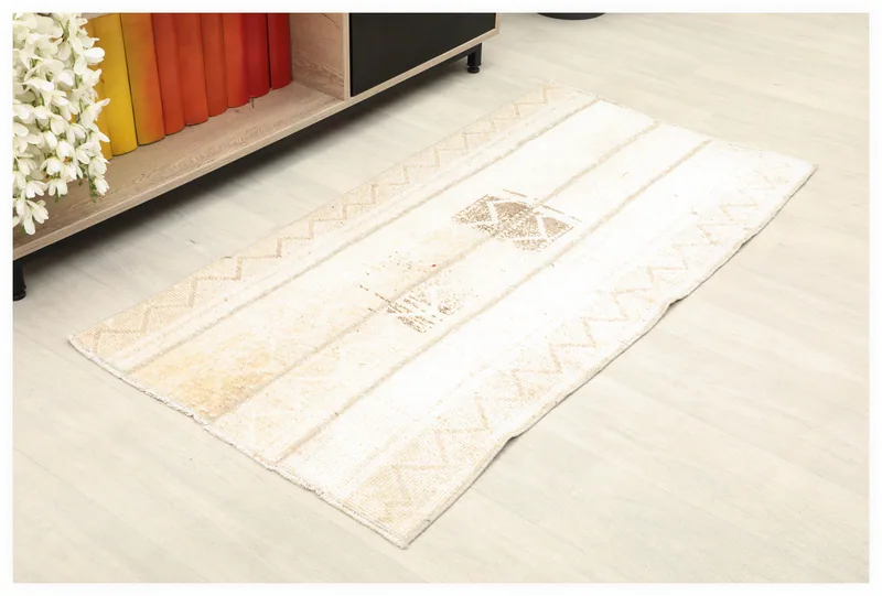 Full top view of the 2'2" x 4'5" vintage ivory and brown Anatolian rug on a white background.