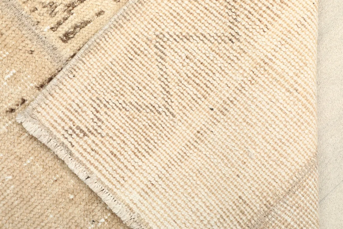 View of the rug's backside, revealing the hand-knotted cotton foundation and tight weave.