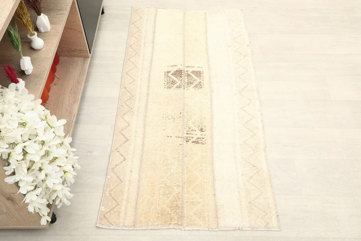 Overhead view of the vintage Anatolian rug, showcasing its full length and geometric patterns.