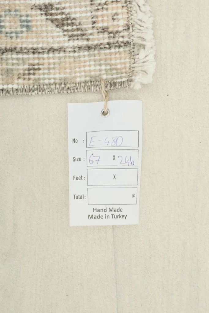 Close-up of the rug's tag, displaying its dimensions in centimeters and 'Hand Made Made in Turkey' label.