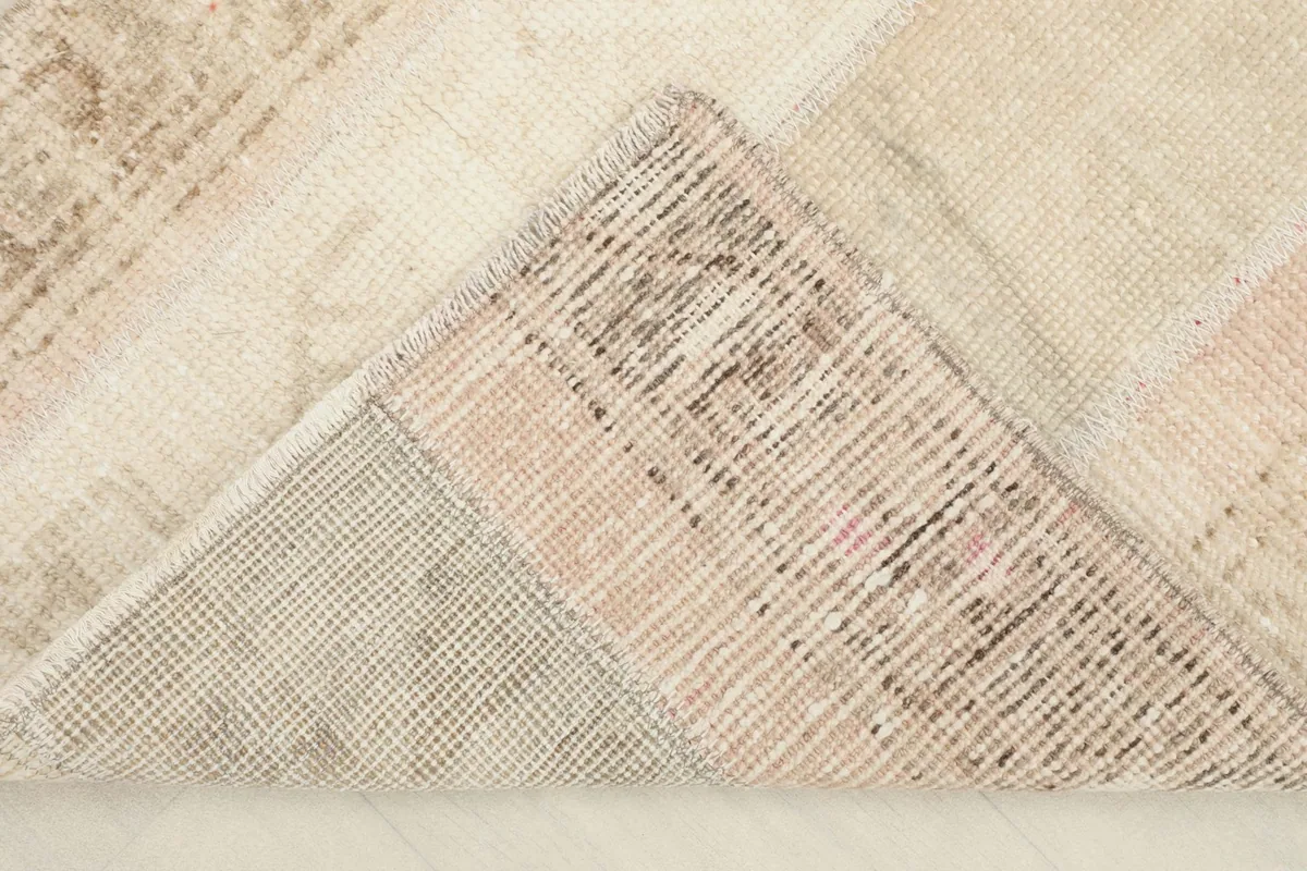 View of the back of the rug, showing the cotton foundation and hand-knotted structure.