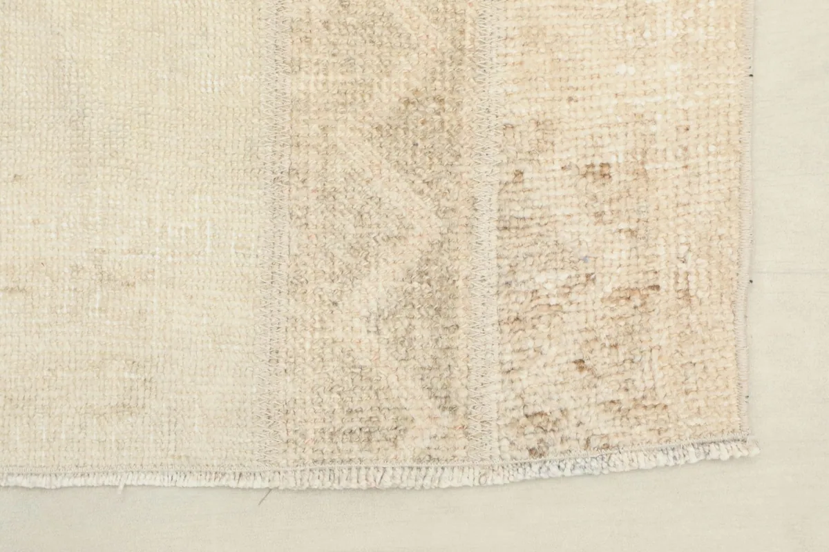 Edge of the rug, showing the finishing and the subtle color transitions.