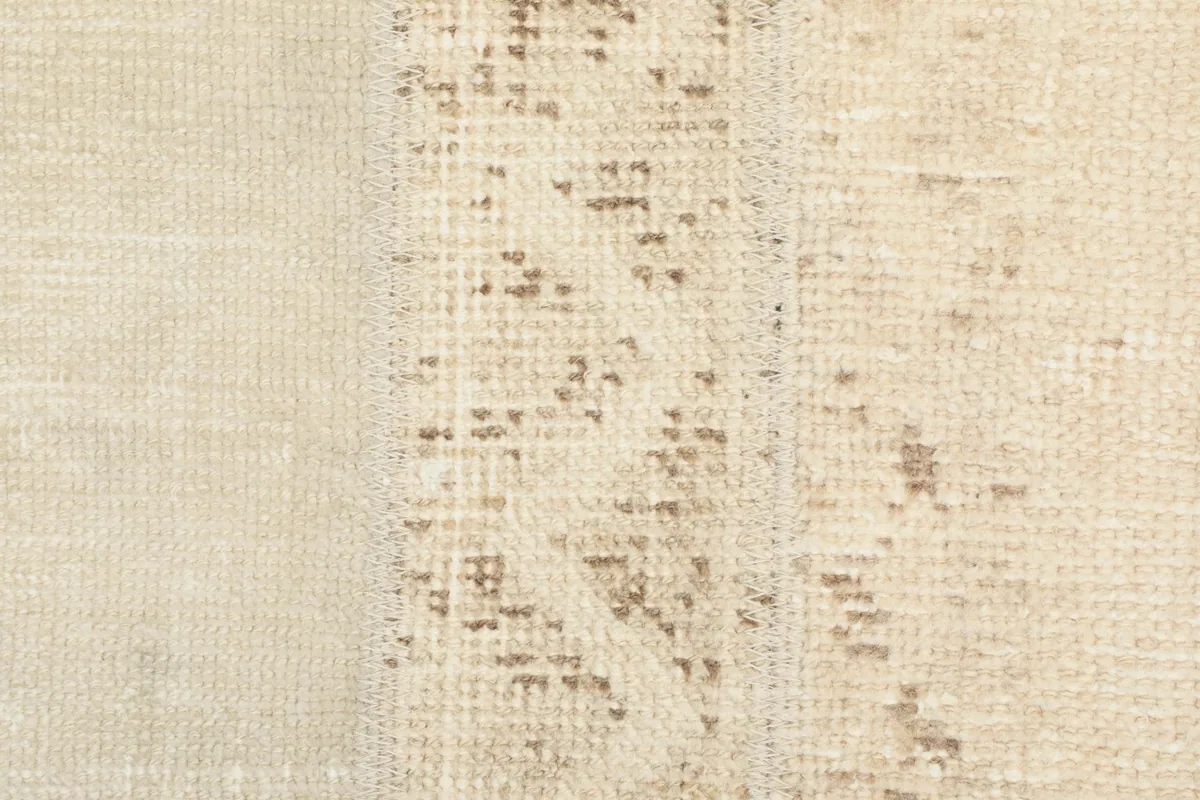 Close-up of the low pile, revealing the hand-knotted construction and natural wear.