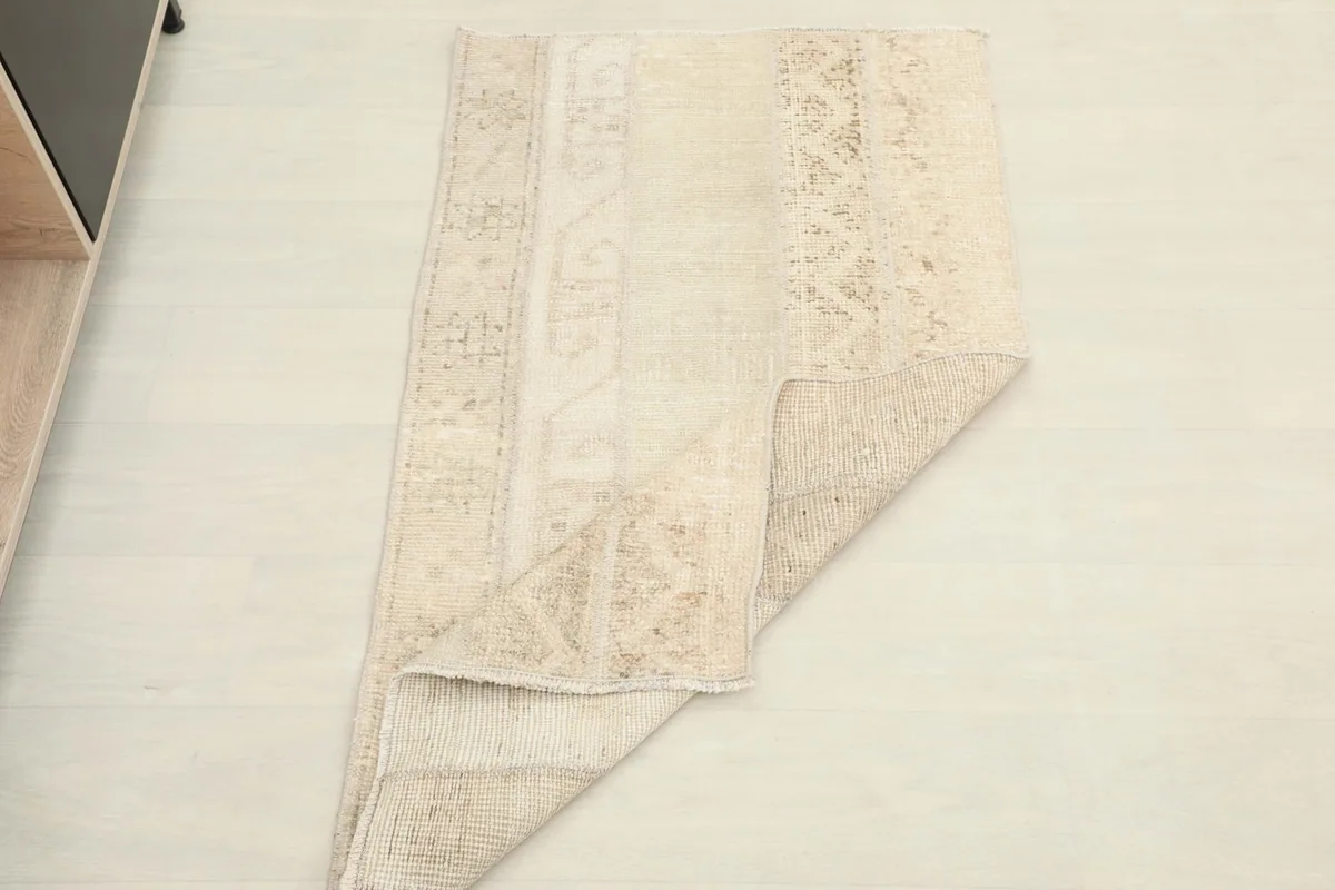 Rug partially folded, demonstrating its flexibility and thickness.
