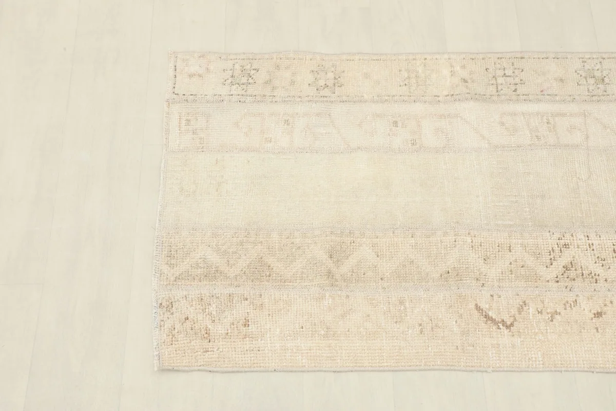 Overhead view focusing on the subtle patterns and color variations within the rug.