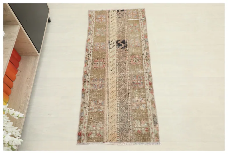 Full top view of the 1'10" x 4'4" beige and rose vintage Anatolian runner rug on a white background.