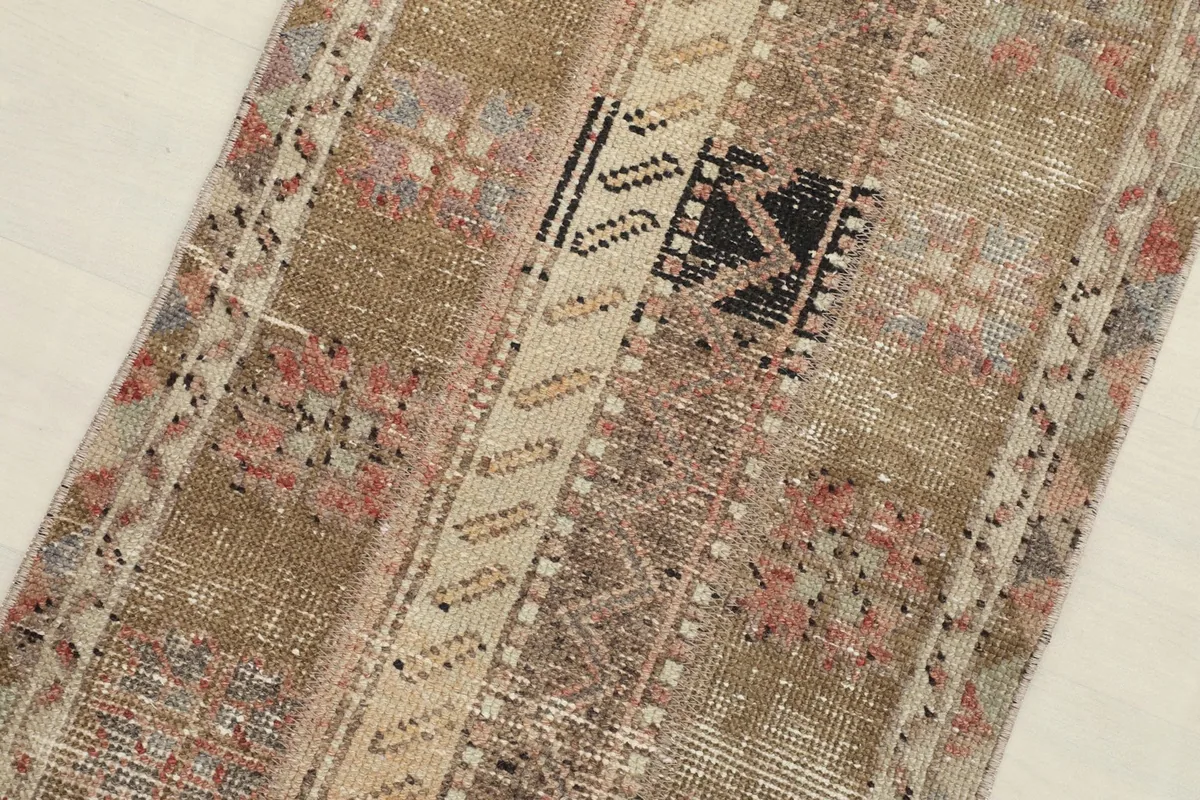 Diagonal view of the rug, focusing on the distinct panels and tribal motifs.
