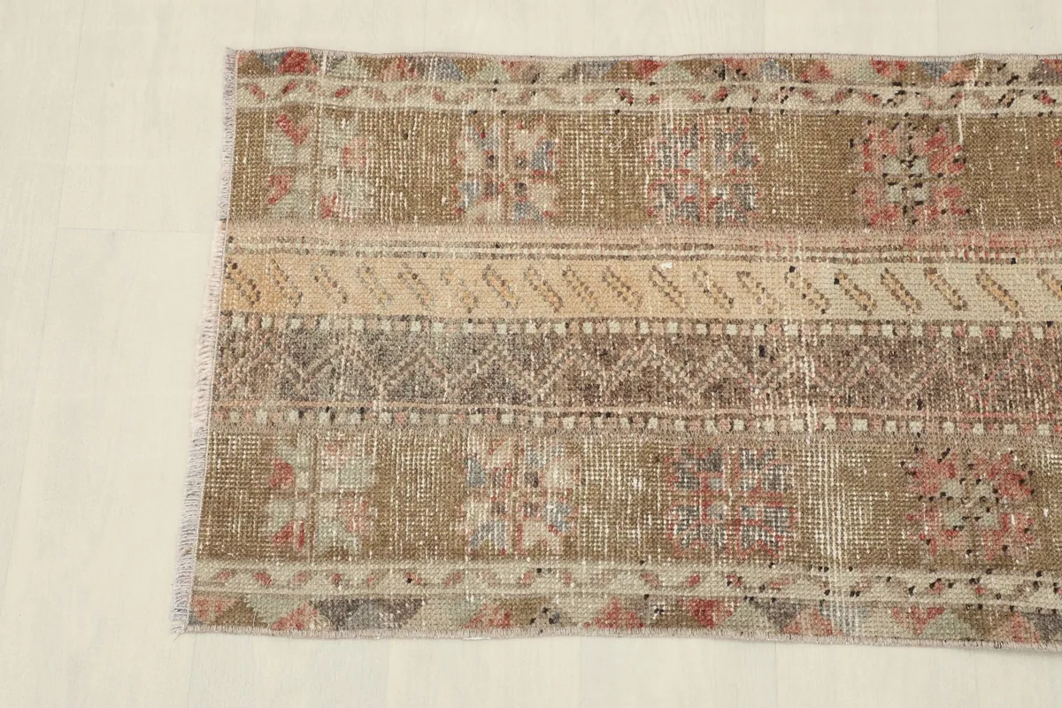 Detail of the rug's surface, showing the subtle color variations and low pile.