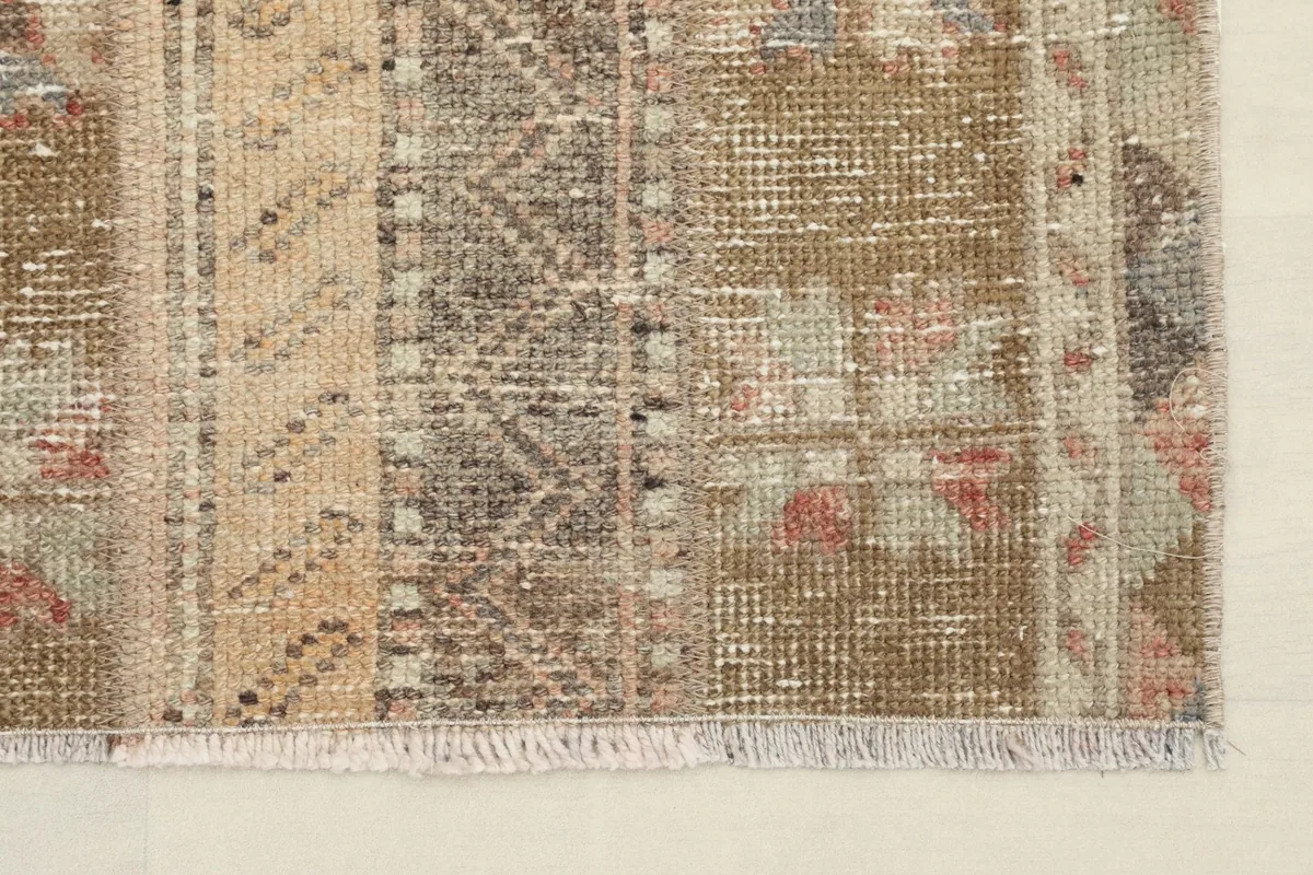 Close-up of the rug's fringe and a corner, showing the texture and weave.