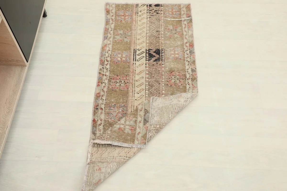 Overhead view of the rug with one corner folded back, showing the thickness and construction.