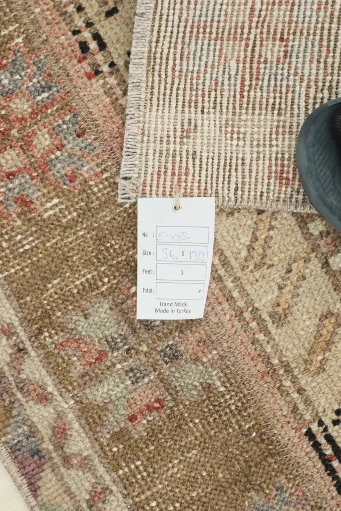 Close-up of a label on the rug, indicating its origin as hand-made in Turkey.