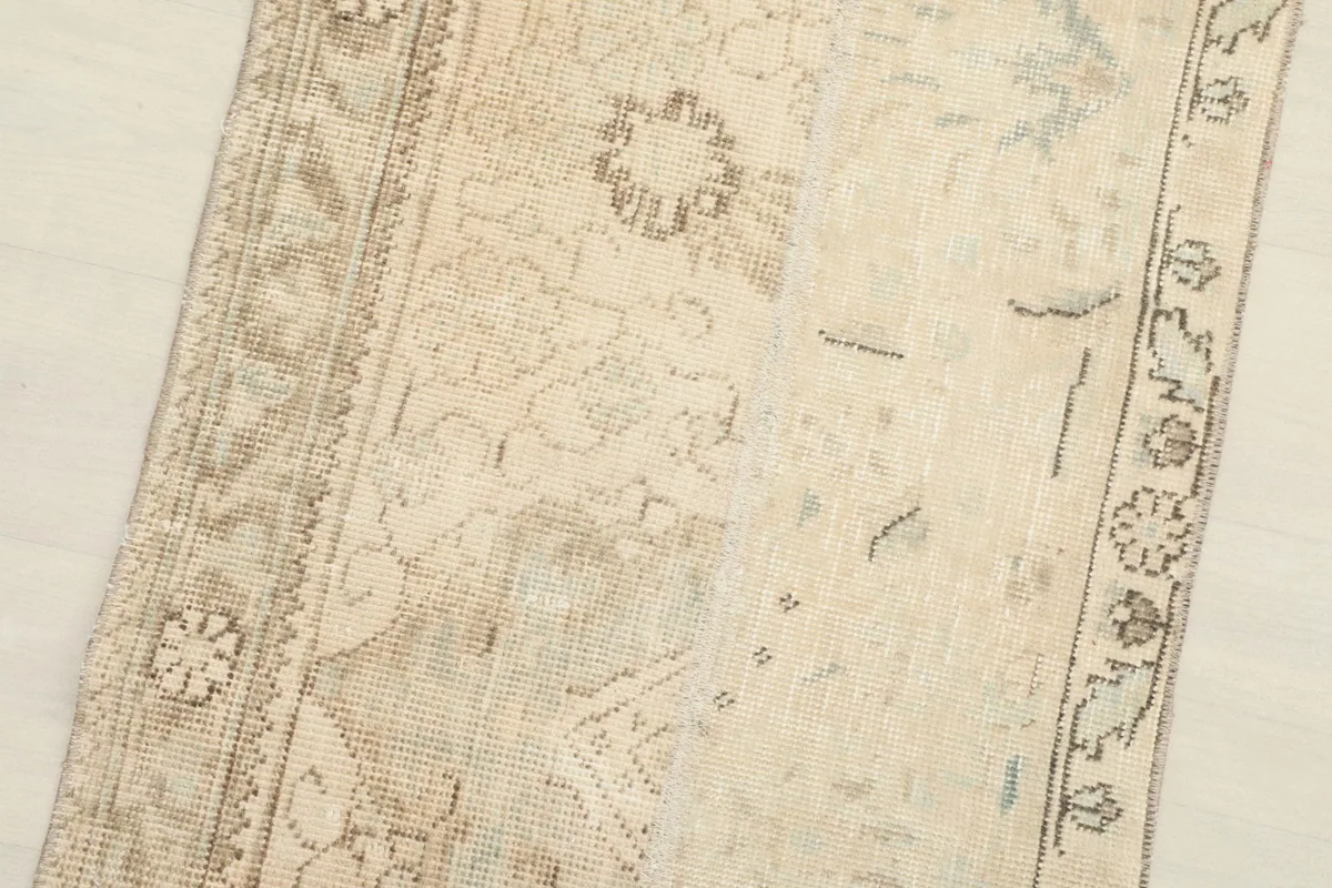 Angled view showcasing the texture and overall design of the beige wool runner.